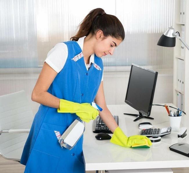 Mujer haciendo limpieza en oficina